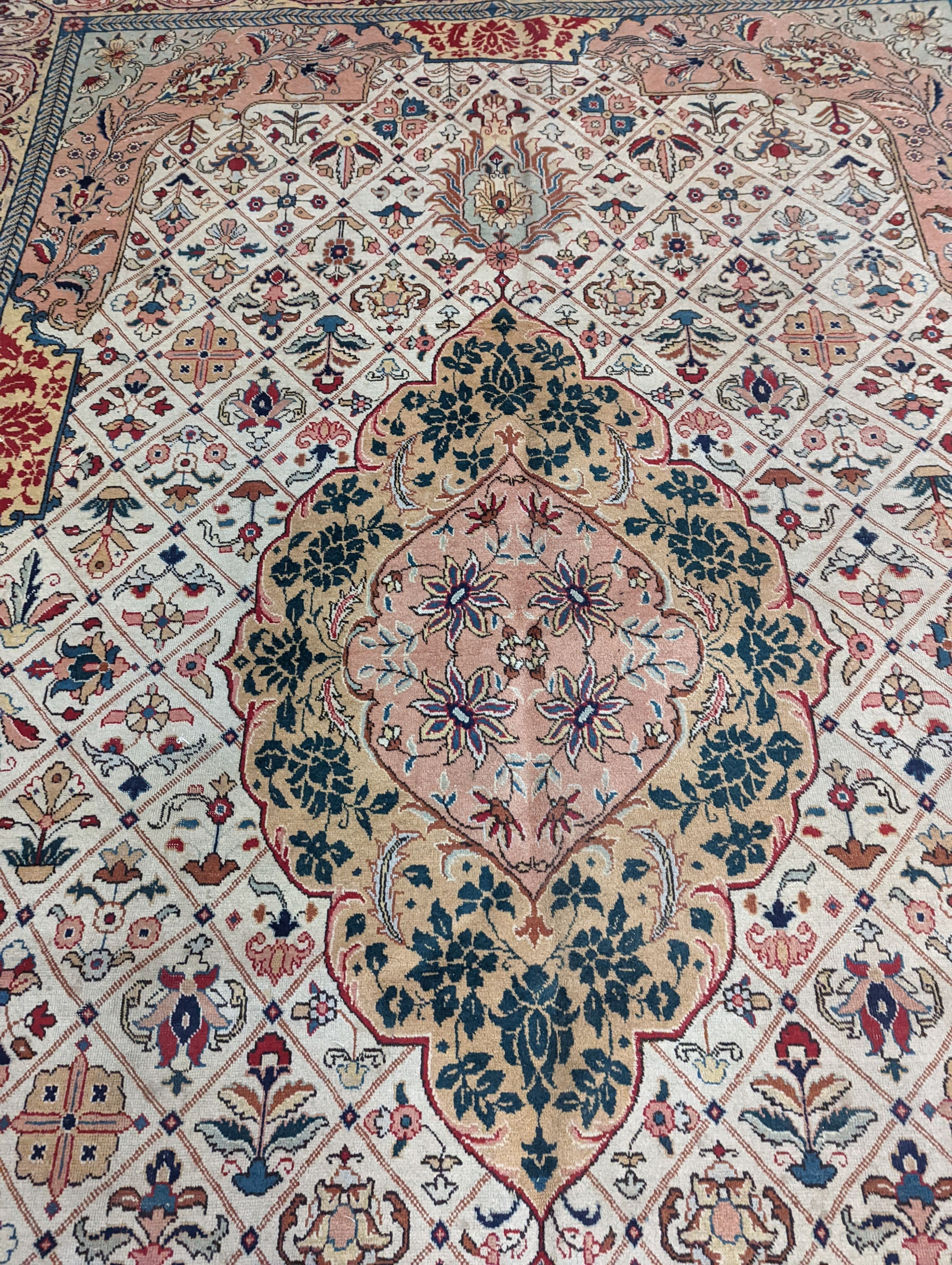 A Tabriz ivory ground carpet, 425 x 306cm